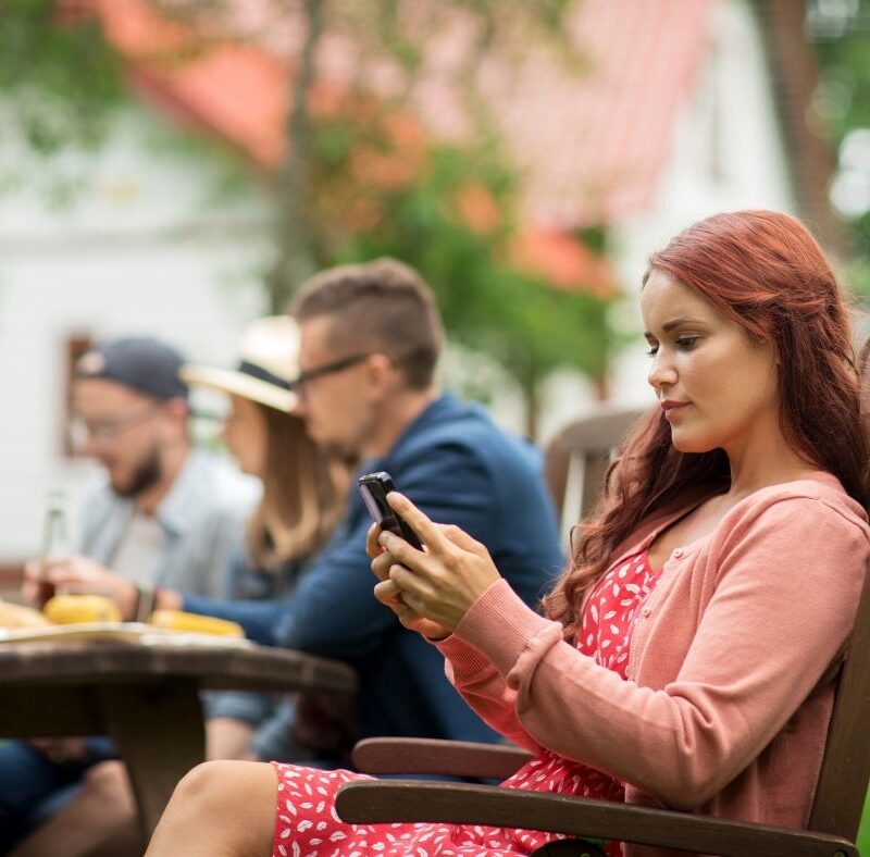 woman on phone at dinner. all in